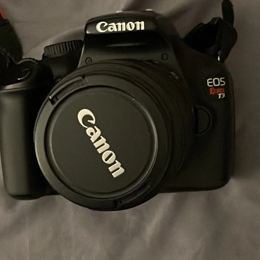TOTAL CAMERA PACKAGE INCLUDES CANON T3 REBEL CAMERA, TELEPHOTO LENSE AND BAG